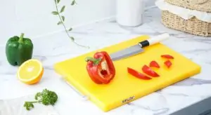 Pepper on a yellow plastic cutting board