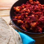 chorizo in a pan with a size of tortillas
